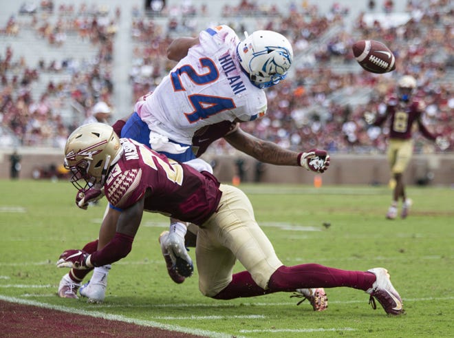 Boise State running back George Holani (24) fumbles as he is hit by Florida State defensive back Hamsah Nasirildeen (23) in the second half of an NCAA college football game in Tallahassee, Saturday. Boise State defeated Florida State 36-31. MARK WALLHEISER/THE ASSOCIATED PRESS
