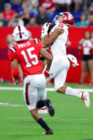 Indiana wide receiver Nick Westbrook, right, makes a catch in front of Ball State cornerback Tyler Potts (15) on his way to a touchdown during the first half of a college football game in Indianapolis, Saturday, Aug. 31, 2019. (AP Photo/Michael Conroy)