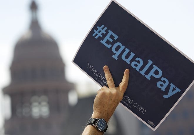 In 2014, supporters for Texas Democratic gubernatorial candidate Wendy Davis protested outside Attorney General and Texas Republican gubernatorial candidate Greg Abbott's office in support of equal pay for women. [RALPH BARRERA / AMERICAN-STATESMAN / FILE]