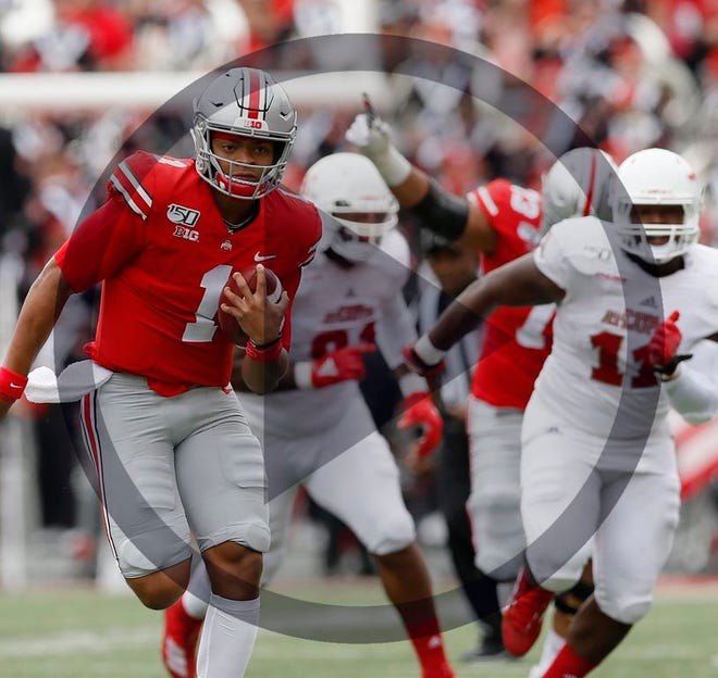 In this file photo Ohio State Buckeyes quarterback Justin Fields (1) runs for a 51-yard touchdown during the first quarter of the NCAA football game against the Florida Atlantic Owls at Ohio Stadium in Columbus on Saturday, Aug. 31, 2019.