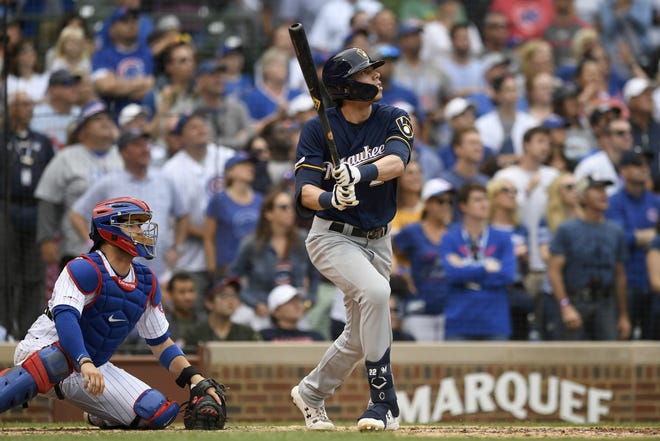 The Milwaukee Brewers' Christian Yelich watches his three-run home run during the ninth inning against the Chicago Cubs on Sunday in Chicago. [PAUL BEATY/THE ASSOCIATED PRESS]