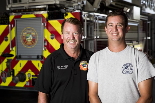 Captain David Jordan, 57, a member of the Panama City Beach Fire Department since 1990 and his son, Andrew Jordan, 32, a firefighter since August 10, 2019, pose for a portrait at Fire Station 31 on Wednesday, August 28, 2019. [JOSHUA BOUCHER/THE NEWS HERALD]