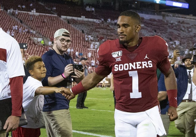 Oklahoma quarterback Jalen Hurts greets a fan after the Sooners' 49-31 season-opening win over Houston in Norman, Okla., on Sunday night. [ALONZO ADAMS/THE ASSOCIATED PRESS]