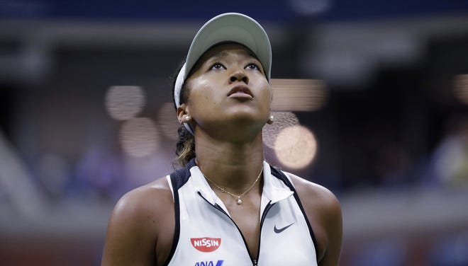 Naomi Osaka, of Japan, looks up at the score board during her match against Belinda Bencic, of Switzerland, in the fourth round of the US Open tennis championships Monday in New York. [FRANK FRANKLIN II/ASSOCIATED PRESS]