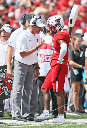 Texas Tech coach Matt Wells gives instructions to Xavier White after the sophomore receiver fumbled near the goal line during the Red Raiders' 45-10 victory Saturday against Montana State. White caught five passes for a team-high 107 yards and a touchdown. [Sam Grenadier/A-J Media]