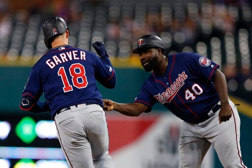 Minnesota Twins' Mitch Garver is greeted by first base coach Tommy Watkins after a solo home run during the ninth inning of a baseball game Saturday, Aug. 31, 2019, in Detroit. Garver's home run was the Twins 268th home run of this season, a MLB record for most home runs by a team in a single season. (AP Photo/Carlos Osorio)