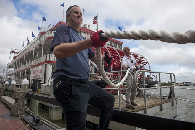 Savannah Riverboat Captain Jonathan Claughton and Cruise Chef Jamie Carver moor the Georgia Queen to large steel pylons near Rousakis Plaza on Monday. Claughton said the mooring prevents the boat from driving over onto the plaza when the Savannah River floods over. [Will Peebles/Savannahnow.com]