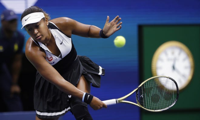 Naomi Osaka returns against Belinda Bencic during the fourth round of the U.S. Open tennis championships Monday in New York. [FRANK FRANKLIN II/THE ASSOCIATED PRESS]