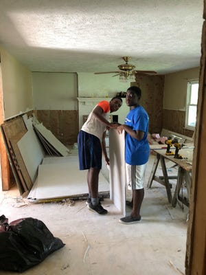 Emmanuel Ofori (left) and his brother William Ofori with Presbyterian Disaster Assistance help rebuild a home in Pender County. [CONTRIBUTED PHOTO]