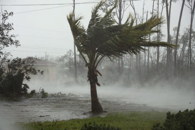 A road is flooded during the passing of Hurricane Dorian in Freeport, Grand Bahama, Bahamas, on Monday. Hurricane Dorian hovered over the Bahamas on Monday, pummeling the islands with a fearsome Category 4 assault that forced even rescue crews to take shelter. [Tim Aylen/The Associated Press]