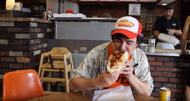 Mark Neurohr-Pierpaoli samples the Newark-style Italian hot dog from Dickie Dee's in Newark in his YouTube show, "I Never Sausage a Hot Dog." [COURTESY OF MARK NEUROHR-PIERPAOLI]