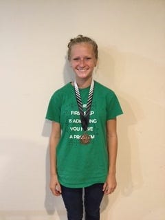 Eleanor Fournier is pictured with her medal from the Normal West Invite. (Courtesy Photo)