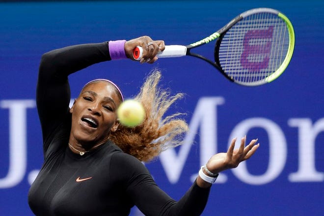 Serena Williams, of the United States, returns a shot to Qiang Wang, of China, during the quarterfinals of the U.S. Open tournament Tuesday in New York.