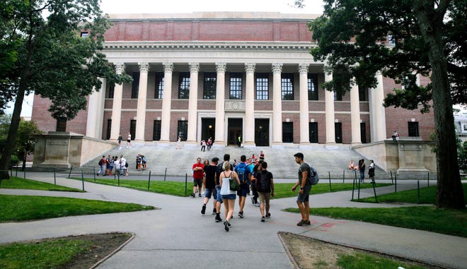 Students walk near the Widener Library in Harvard Yard at Harvard University in Cambridge, Mass., on Aug. 13, 2019. (AP Photo/Charles Krupa, File)