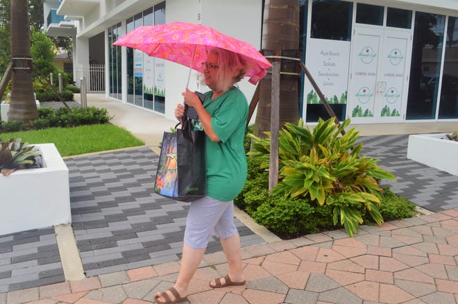 Anna Leon walks to the Dollar General in downtown Lake Worth Beach Tuesday morning to buy coffee creamer. [Photo by Bailey LeFever/Tpalmbeachpost.com]