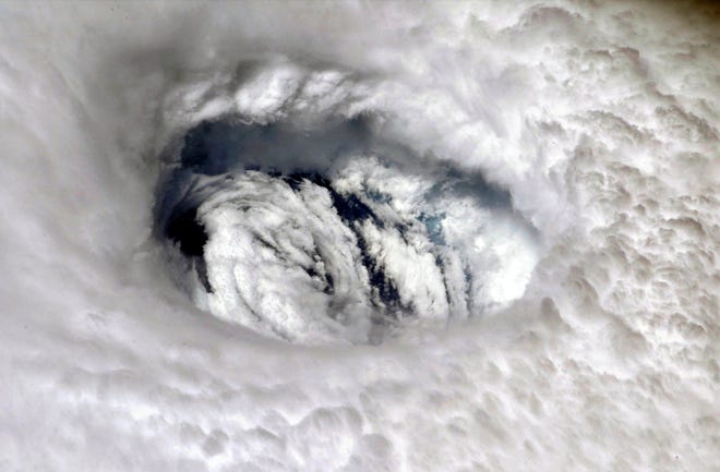 A photo provided by NASA shows the eye of Hurricane Dorian over the Bahamas on Monday. Dorian, now a Category 2 storm, finally began to slowly move away from the Bahamas early Tuesday as the U.S. waits to see what destructive path it would take. [CHRISTINA KOCH/NASA via The New York Times)]
