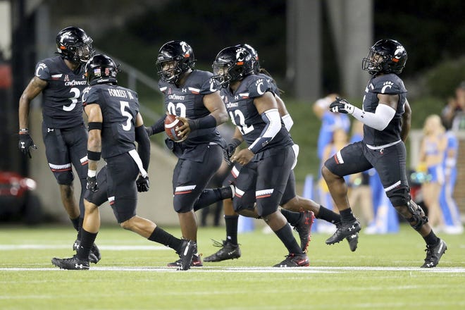 Cincinnati defensive tackle Curtis Brooks leaves the field after recovering a fumble during the Bearcats' 24-14 season-opening win over UCLA on Thursday. [Kareem Elgazzar/The Cincinnati Enquirer]
