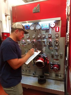 Engineer Lucas Rollins gets a Gastonia Fire Department truck ready for deployment. [Gastonia Fire Department/Special to The Gazette]