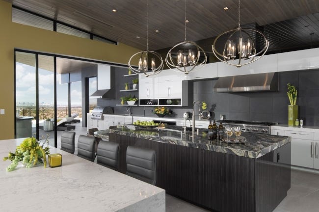 The dining area and kitchen of the New American Home are captured in this well-lighted photo. [STATEPOINT]