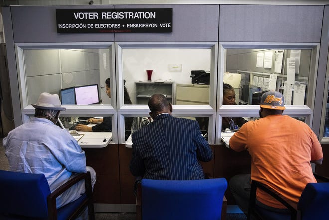 FILE -- People register to vote on the day after FloridaþÄôs Amendment 4 went into effect, restoring the right to vote to more than a million former felons in Doral, Fla., Jan. 8, 2019. FloridaþÄôs Republican-controlled House is developing a bill that would require former felons to pay fees and fines before having their voting rights restored. (Scott McIntyre/The New York Times)