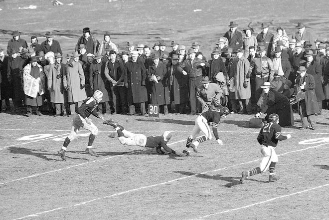 In this Dec. 14, 1941, file photo, Chicago Bear Hugh Gallarneau (8) stumbles as a Green Bay Packers defender attempts a diving tackle during a game in Chicago. The NFL's most ancient rivals open the league's 100th season in Chicago Thursday.      

[Associated Press File Photo]