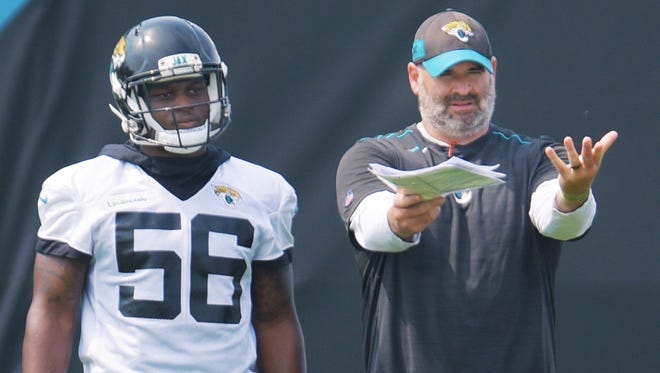 Jaguars rookie linebacker Quincy Williams listens to position coach Mark Collins during an OTA practice in May. [Bob Self/Florida Times-Union]