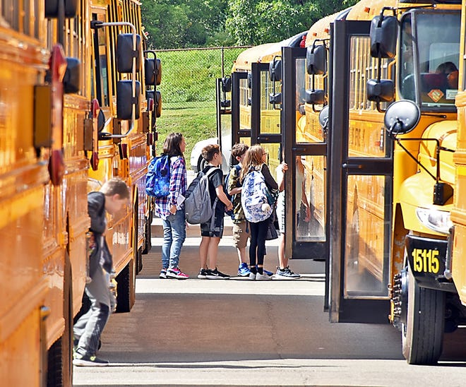 Corning-Painted Post Middle School sixth-graders board their buses at the end of the day Wednesday. [James Post/The Leader]