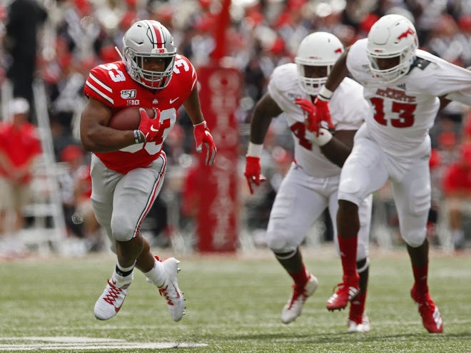 Ohio State Buckeyes running back Master Teague III (33) rushes upfield ahead of Florida Atlantic Owls defensive end Leighton McCarthy (13) during the fourth quarter of the NCAA football game at Ohio Stadium in Columbus on Saturday, Aug. 31, 2019. Ohio State won 45-21.[Adam Cairns/Dispatch]