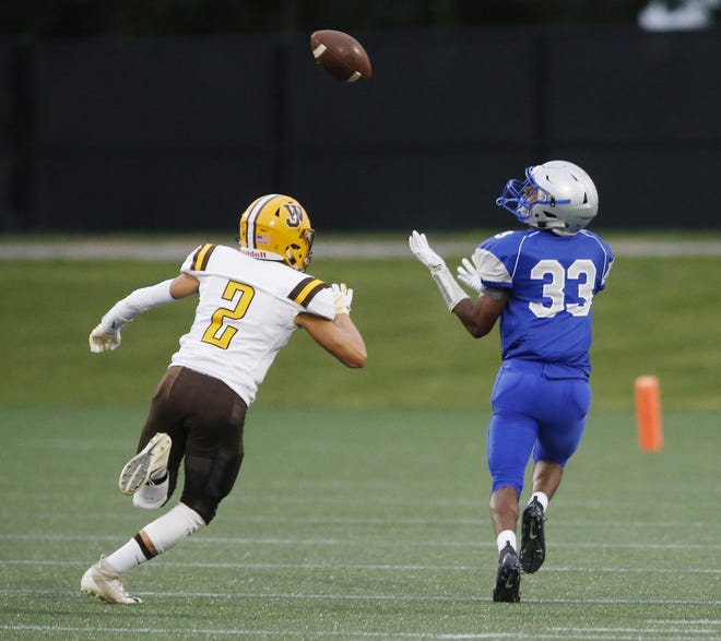Tyrese Hudson (33) of Ready makes a catch and runs for a touchdown, eluding West Jeffersonl's Trent Eitel during the first quarter at Fortress Obetz on Friday night. Despite the touchdown, West Jefferson rolled to a 55-24 victory. [Fred Squillante/Dispatch]