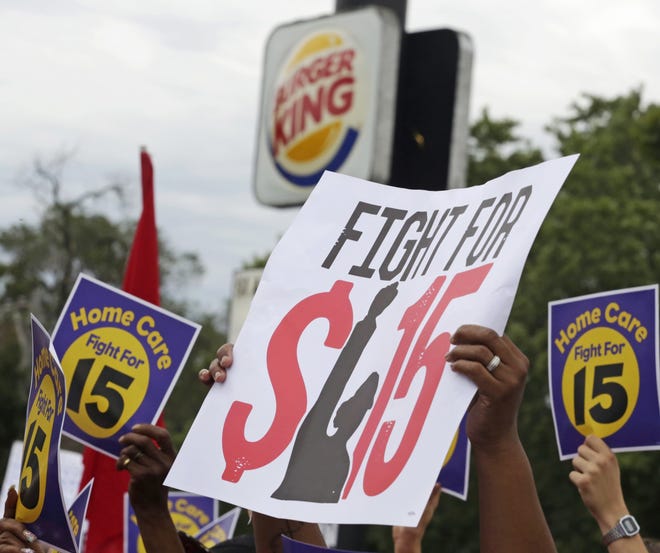 Protesters participate in a rally in support of the campaign to raise the minimum wage for employees to $15 an hour. [AP Photo/M. Spencer Green, File]