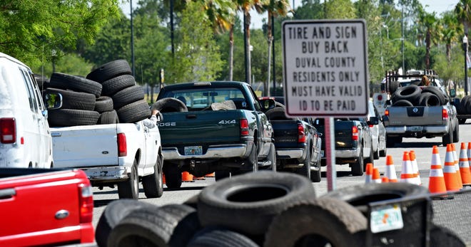 Residents seeking to get rid of old tires formed a steady line into Parking Lot J during the fourth annual Tire & Sign Buyback event in this 2017 file photo. City workers and others loaded used tires into dumpsters. [Bob Mack/Florida Times-Union]