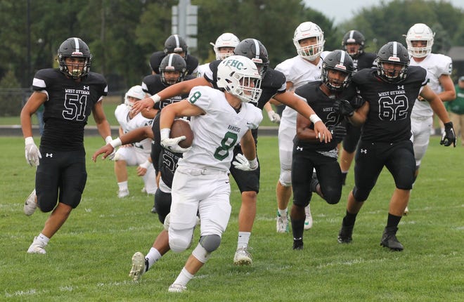 Forest Hills Central's Jackson Clay outruns Panther defenders as he runs to a 38-yard touchdown run as West Ottawa lost 30-7 in the home opener. [Chris Zadorozny/Sentinel contributor]