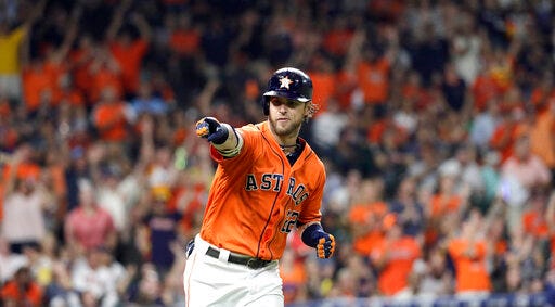 Houston Astros' Josh Reddick points to the dugout after hitting a home run against the Seattle Mariners during the fourth inning of a baseball game Friday, Sept. 6, 2019, in Houston. (AP Photo/David J. Phillip)