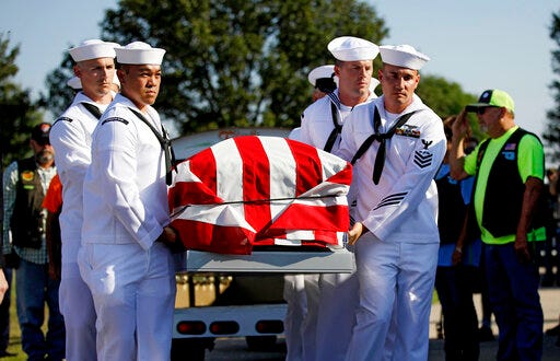 Sailors carry the casket of World War II veteran Herman White during his funeral Wednesday, Sept. 4, 2019. White had no surviving family, so the Brown-Dugger Funeral Home put out a notice asking for people to attend his funeral. (Mike Simons/Tulsa World via AP)