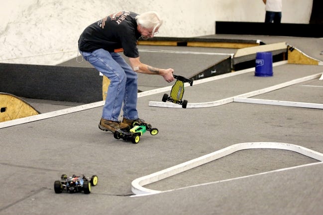 Gerald Donelson runs to flip over a stuck 1/10 scale remote-controlled car during a race at 405 R/C Raceway and Hobbies in Oklahoma City on Aug. 31. 405 R/C Raceway and Hobbies hosts indoor races for remote-controlled cars on Wednesdays and Saturdays. [Bryan Terry/The Oklahoman]