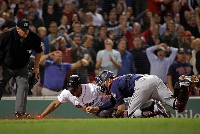 Rafael Devers is tagged out at the plate by Jason Castro, ending Thursday's game.