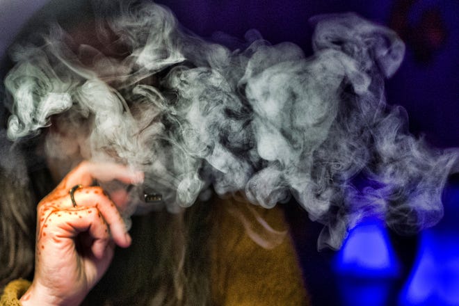 U.S. health officials are again urging people to stop vaping until they figure out why some are coming down with serious breathing illnesses. [Richard Vogel/The Associated Press]