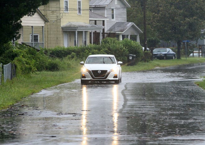 High water from heavy rains flows in the Duffyfield neighborhood in New Bern, N.C., September 6, 2019, after Hurricane Dorian storms across the North Carolina region overnight. [Gray Whitley / Sun Journal Staff]