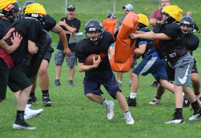 Wellsville quarterback Liam McKinley runs up the middle during a preseason practice. The Lions kick off tonight at 7 p.m., hosting LeRoy. [Chris Potter/The Spectator]