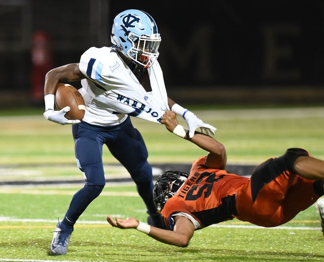 Beaver Falls' Anthony Cousar attempts to bring down Central Valley's Myles Walker during Friday night's game at Reeves Field in Beaver Falls. [Sally Maxson/For BCT]