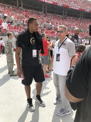 Zed Key, a member of the 2020 recruiting class, speaks with Ohio State men's basketball coach Chris Holtmann before the football team's game against Cincinnati while on his official visit. [Adam Jardy/Dispatch]