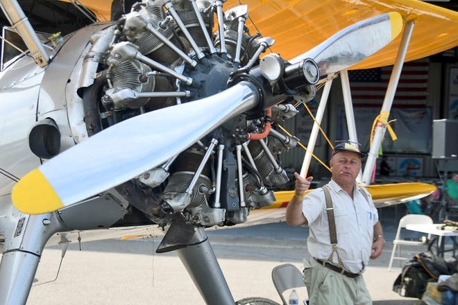 Stearman pilot Hans Nordsiek of Holland tells stories of his childhood and how he became a pilot during the Stearman Fly-In Saturday afternoon at the Galesburg Munincipal Airport. [BILL NICE/The Register-Mail]