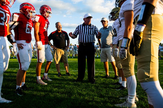 Glenwood coach David Hay and Sacred Heart-Griffin coach Ken Leonard stand with their teams for the coin toss prior to kickoff of Friday's game. [Justin L. Fowler/The State Journal-Register]