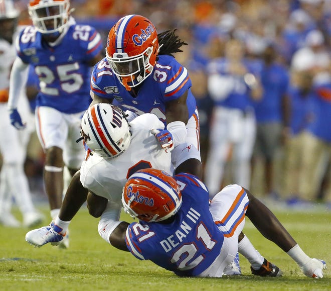 Florida defensive backs Shawn Davis (31) and Trey Dean III (21) get in on a tackle during the first half Saturday against UT Martin at Ben Hill Griffin Stadium. [Brad McClenny/Staff photographer]
