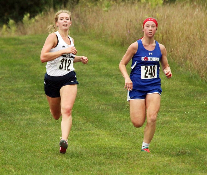 Hillsdale Academy's Hannah Wilkinson (left) races Lenawee Christian's Elizabeth Scharer to the finish line during Friday's Invite at Hayden Park. (JAMES GENSTERBLUM/Hillsdale Daily News)