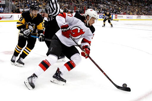 FILE - In this Jan. 28, 2019, file photo, New Jersey Devils' Pavel Zacha, center, skates during an NHL hockey game against the Pittsburgh Penguins in Pittsburgh, Monday, Jan. 28, 2019. Devils general manager Ray Shero says he is still attempting to sign Zacha amid concerns the former first-round draft pick will play in the Kontinental Hockey League this season. (AP Photo/Gene J. Puskar, File)