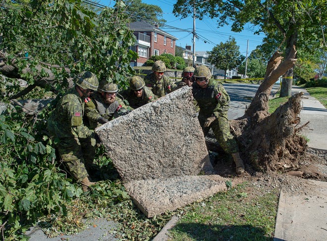 Members of the 4 Engineer Support Regiment from Camp Gagetown assist in the cleanup in Halifax, Nova Scotia on Monday, Sept. 9, 2019. Hurricane Dorian brought wind, rain and heavy seas that knocked out power across the region. (Andrew Vaughan/The Canadian Press via AP)