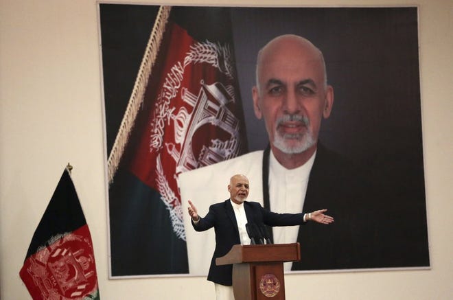 FILE - In this Sept. 9, 2019, file photo, Afghan President Ashraf Ghani speaks during a ceremony to introduce the new chief of the intelligence service, in Kabul, Afghanistan. President Donald Trump's halt to U.S.-Taliban talks looks like a gift to the beleaguered Afghan president, who has insisted on holding a key election in less than three weeks’ time despite widespread expectations that a peace deal would push it aside. (AP Photo/Rahmat Gul, File)