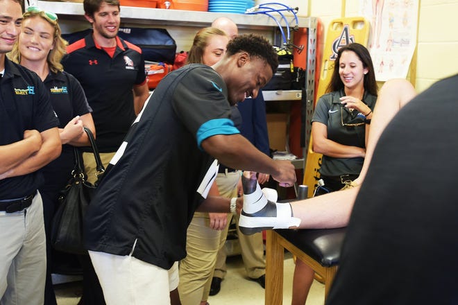Jacksonville Jaguars receiver Dede Westbrook takes part in an ankle-taping competition with Duval County public school athletic trainers. He met with them prior to a Tuesday news conference announcing that two final Duval high schools had joined Project 17, a 2015 initiative to install trainers at all 17 Duval high schools by 2020 to reduce sports injuries. [Rick Wilson/Jacksonville Jaguars]