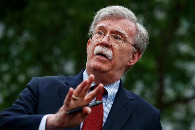FILE - In this May 1, 2019 file photo, national security adviser John Bolton talks to reporters outside the White House in Washington. Trump says he fired Bolton, saying they 'disagreed strongly' on many issues. (AP Photo/Evan Vucci)
